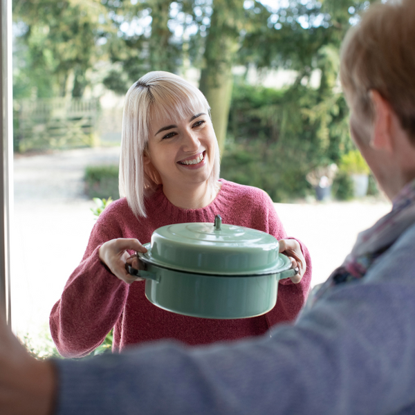 Lady bringing food to neighbour