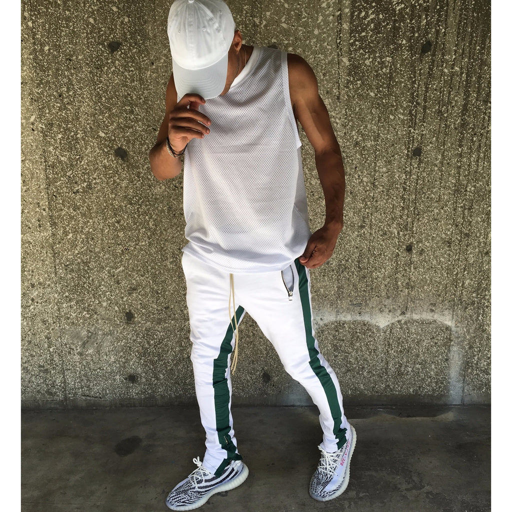 green track pants with white stripe