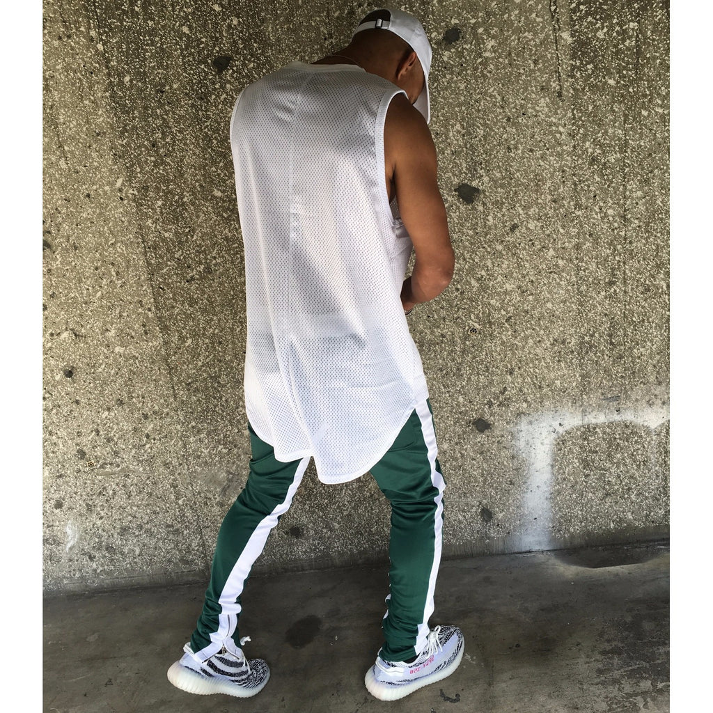 green track pants with white stripe