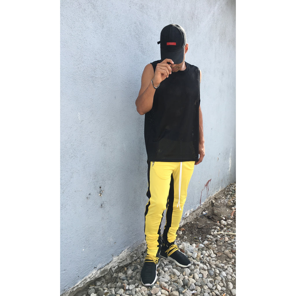 yellow track pants with black stripe