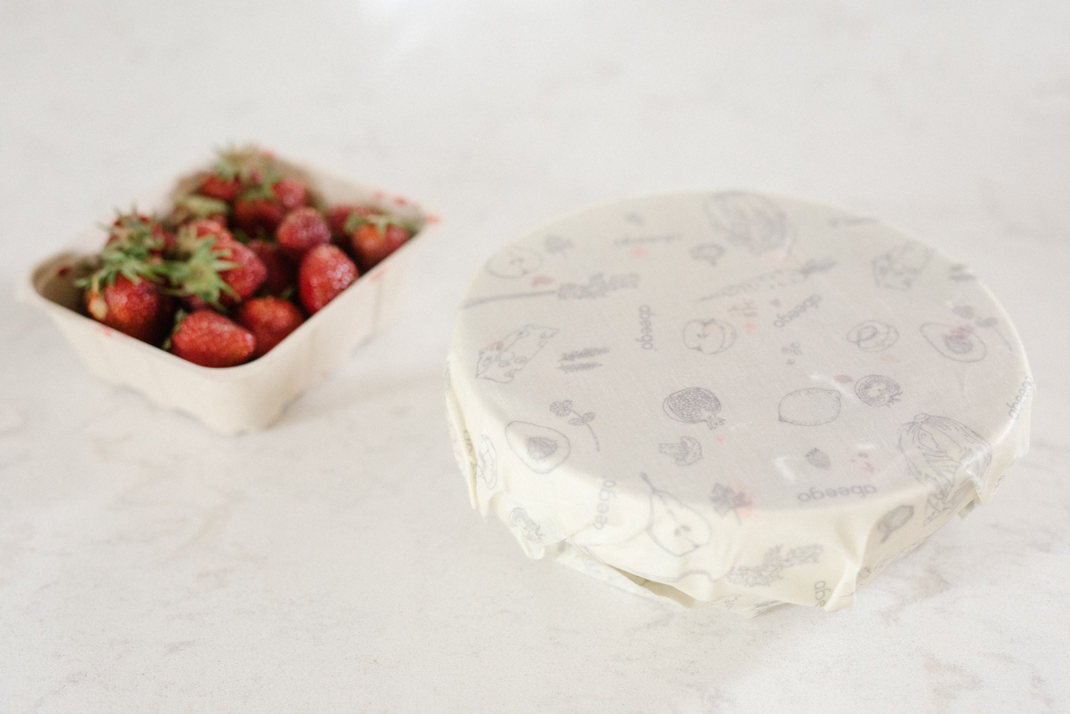 Cover a bowl with Abeego wraps to keep strawberries fresh