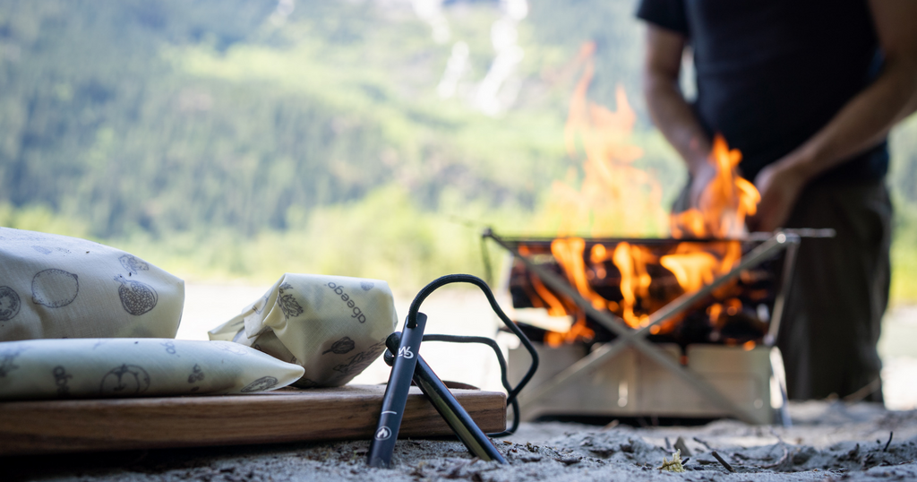 Wolf and Grizzly Fire Set and Abeego-wrapped food in foreground with fire blazing in background