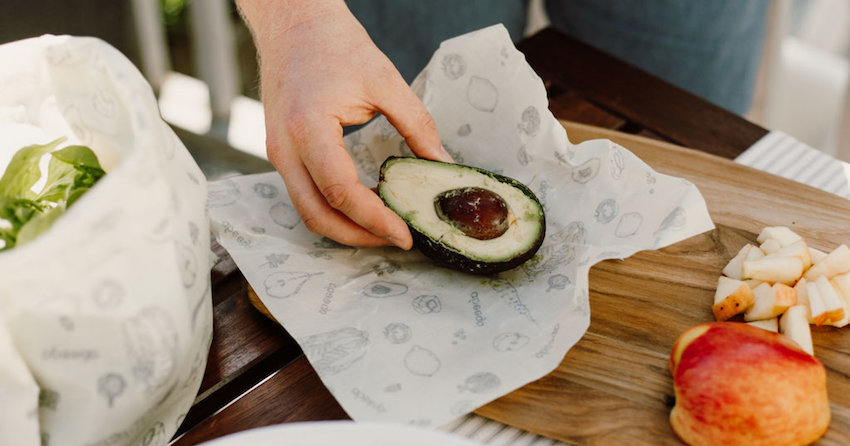 halved avocado being wrapped in Abeego