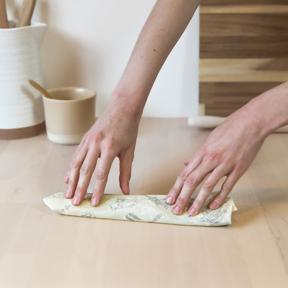 Wrapping green onions with a small rectangular Abeego food wrap.Abeego