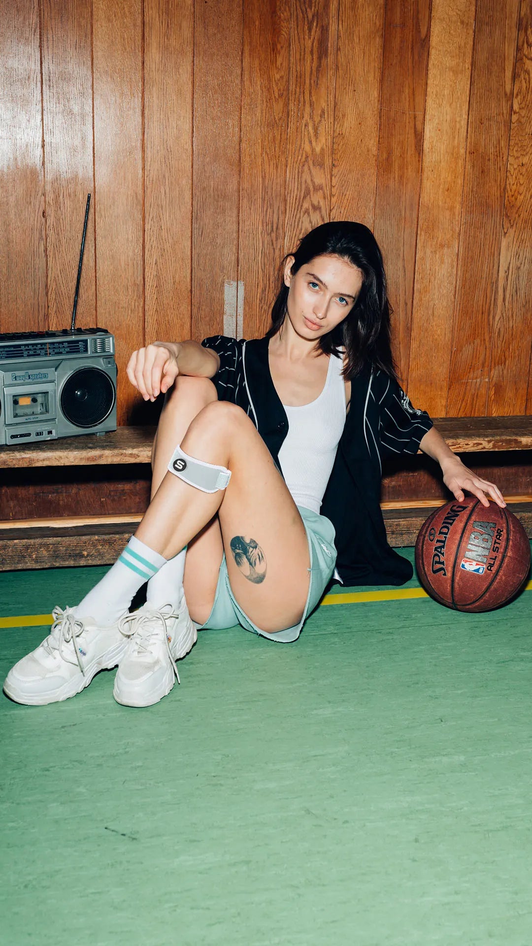 Adjustable black patella strap with cushioned support for knee pain relief and improved athletic performance.