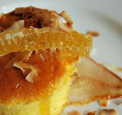 Pear and raw honey sponge pudding topped with a chunk of honeycomb