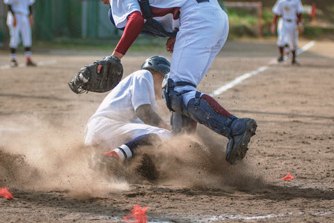 Baseball player sliding on base