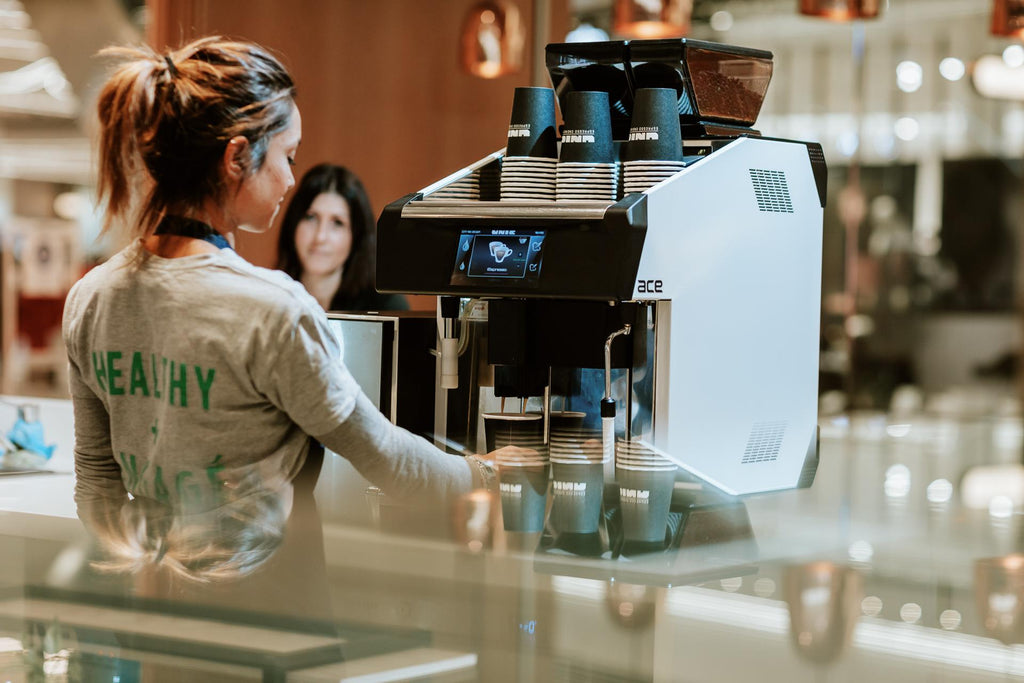 A barista operating a Unic Tango Duo ST