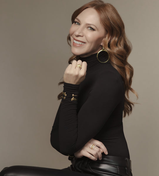 Kristin Detterline wears gold REALM Fine + Fashion Jewelry with black and leather