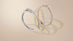 Trio of cuff bracelets in silver, gold, rose gold, each sparkling with over 150 hand prong-set white cz stones