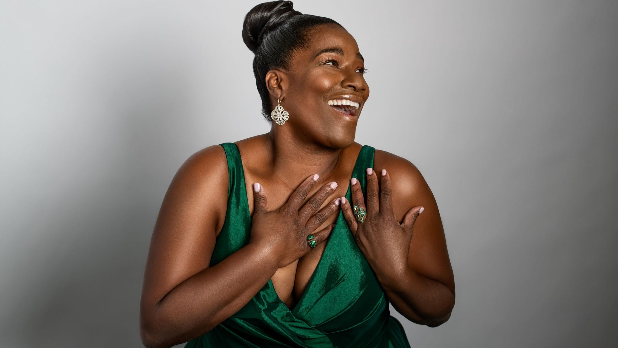 Beautypreneur Ky'sha Woods wears an emerald gown and CZ Vert jewelry from REALM