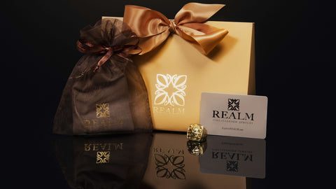 Complimentary luxe gift packaging from REALM Fine + Fashion Jewelry includes organza bag, suede pouch and gold bag tied with satin bow. Gift cards available for purchase.