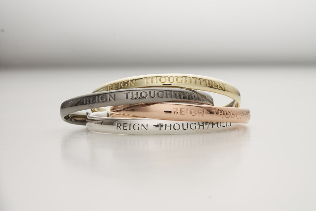stack of engraved cuffs in 4 precious metals