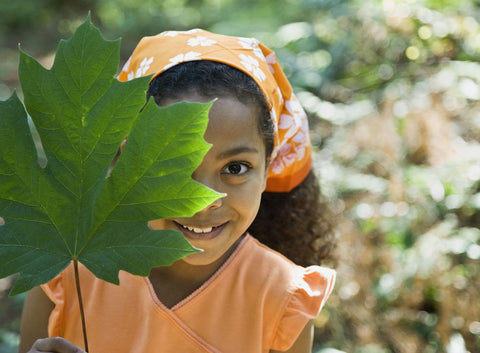 little girl holding leaf during scavenger hunt