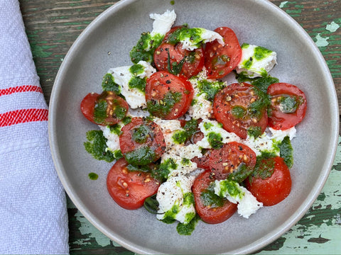 TOMATO AND MOZZARELLA SALAD WITH FRESH BASIL OIL