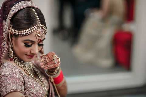 a bride with hands decorated with henna