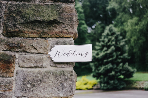 the inscription wedding on the signpost on the stone wall