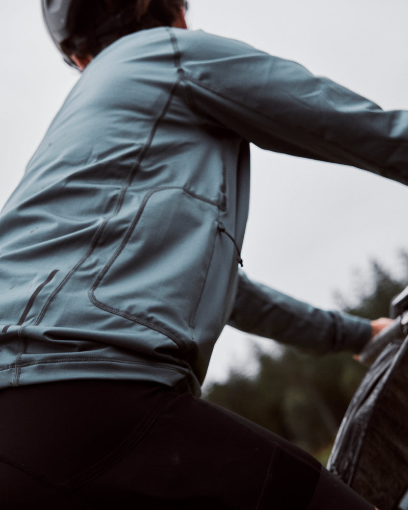 Close up of blue cycling top with zipped right side pocket