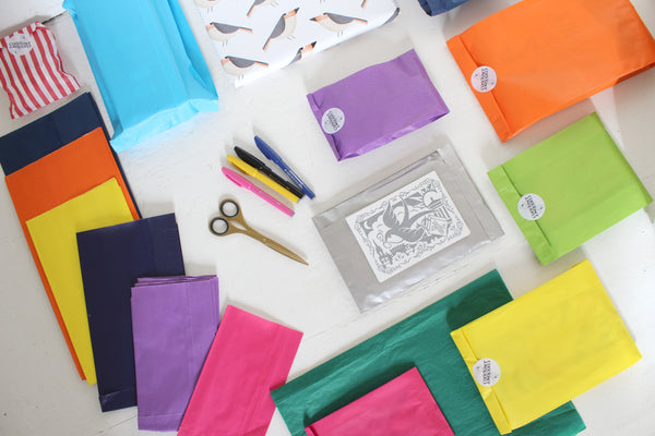 colourful paper bags, scissors and a hand written card