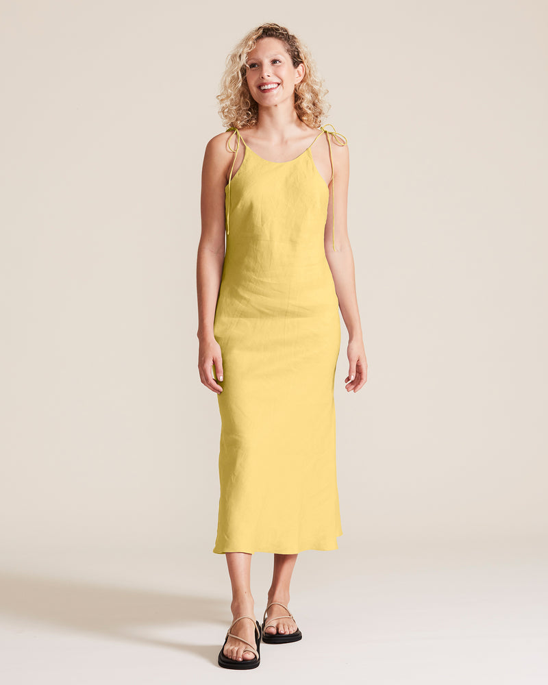 woman wearing yellow halter dress linen