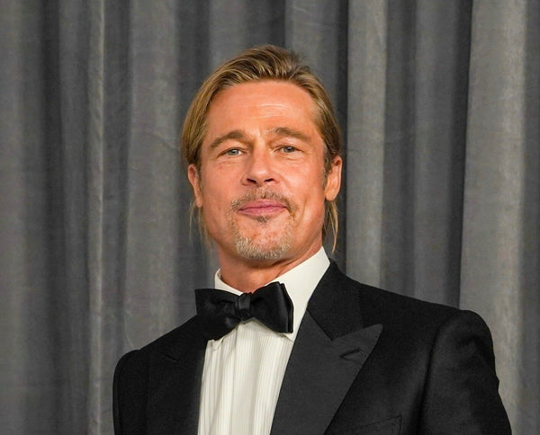 How to get the Brad Pitt haircut - Long hair tied back in a messy bun at the Oscars 2021