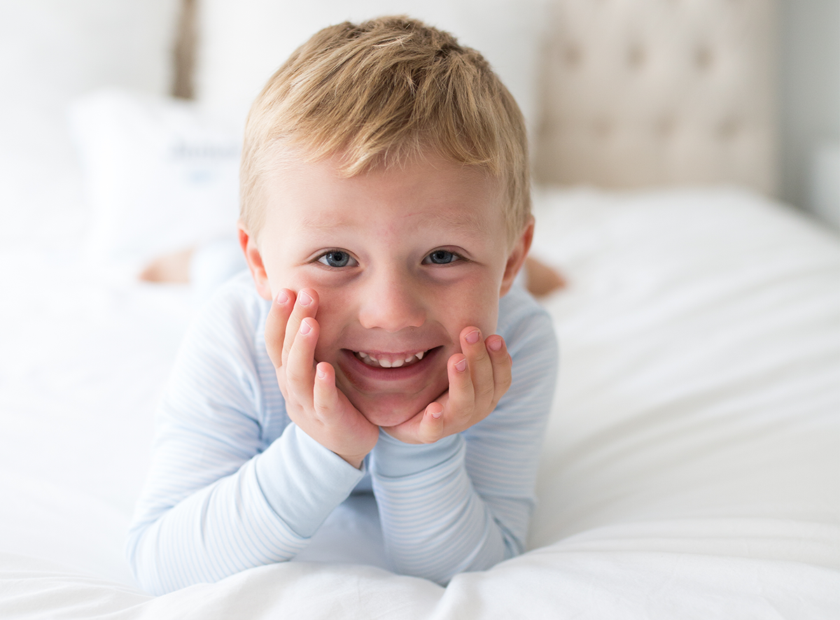 Kid in S+N pajamas smiling
