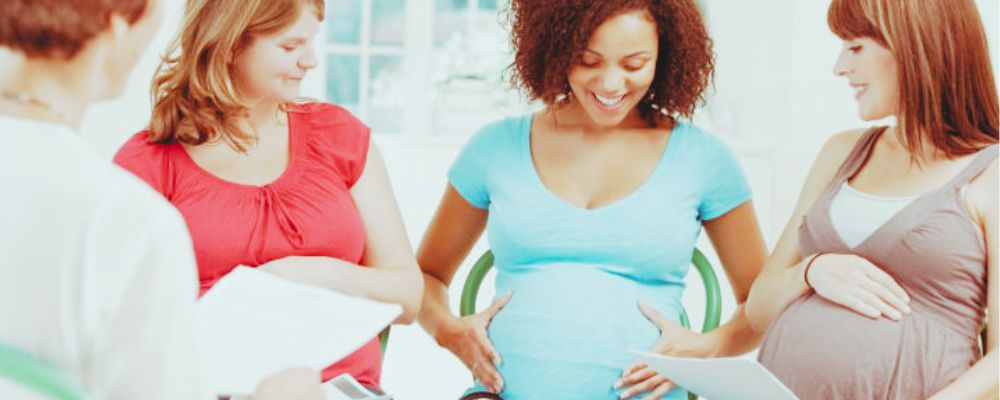Expecting moms talking at a prenatal class