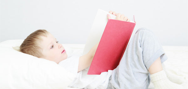 Child reading a red book.