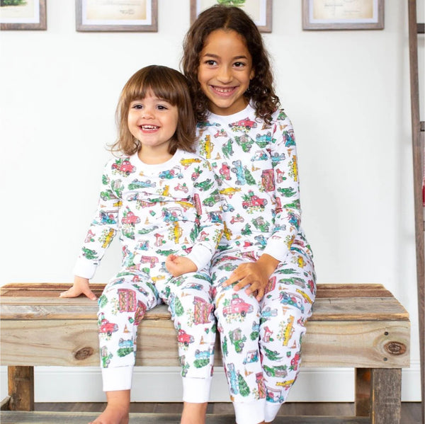 Happy children posing in colorful pajama prints.