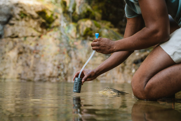 Man with RapidPure straw in body of water