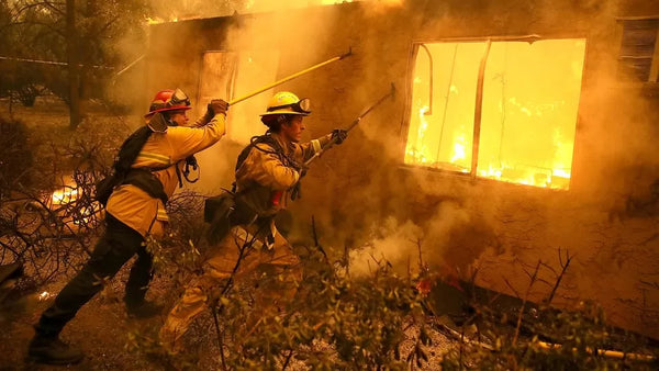 Firefighters in California attempt to stop flames spreading from this home onto a nearby apartment complex Source: BBC