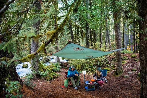 Couple camping outside in forest