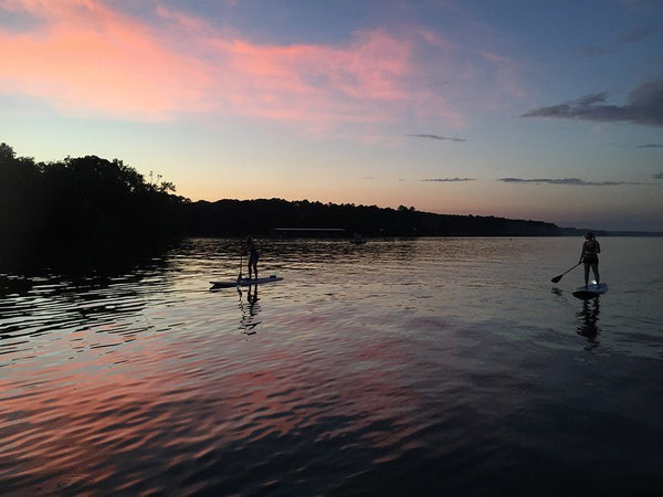 Two people paddleboard on lake Source: Jayne Cagle