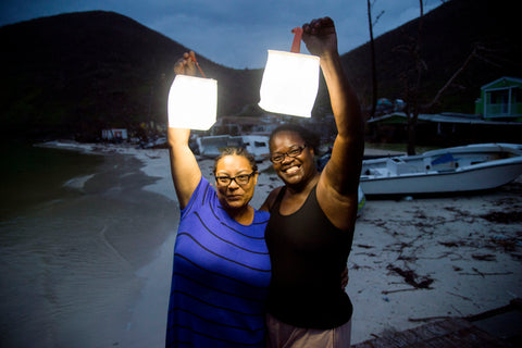Two women with light after hurricane.