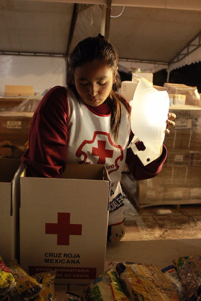 Woman distributing medical aid by LuminAID light in Mexico