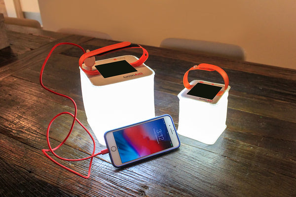 LuminAID lanterns charging phone