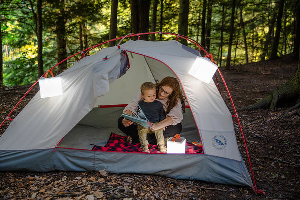 Woman and little boy in a tent out in nature. Source: Nick Zupancich