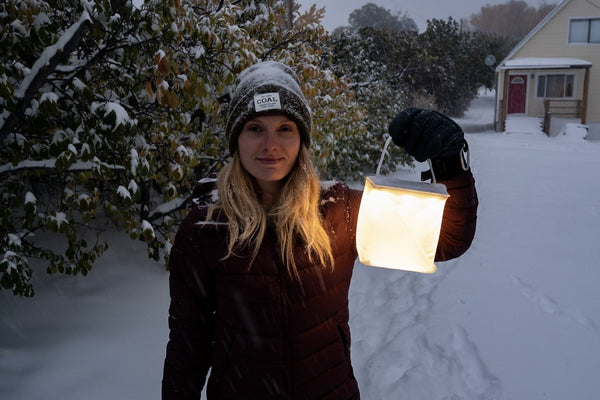 Woman holding LuminAID Firefly outside in the snow  Source: Kati Whelan