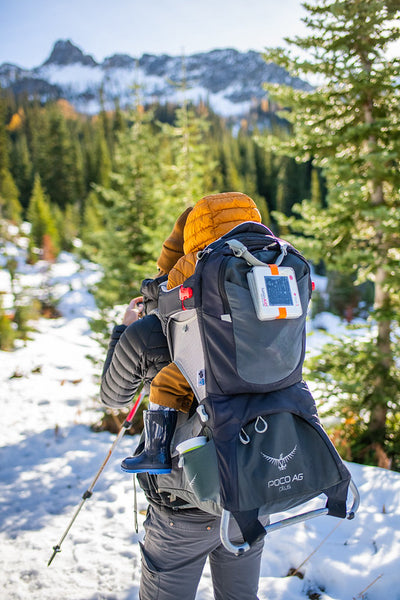 Parent carrying a child on their back in the snow of the North Cascades Source: Megan McKay 