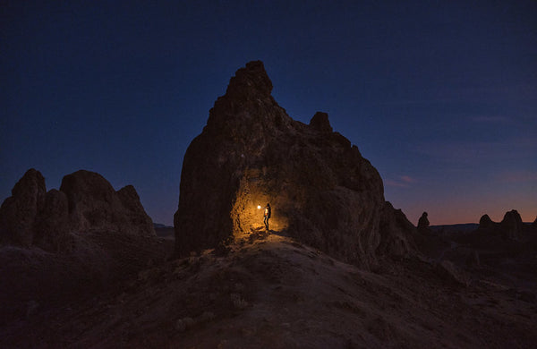 LuminAID user by a large rock at Pinnacles National Park Source: Ura Druchuk 