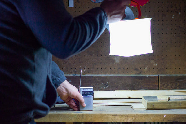 Man with source of a LuminAID light in a black out