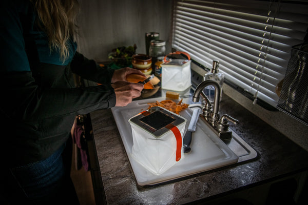 Person preparing a meal in the kitchen. Source: Megan McKay