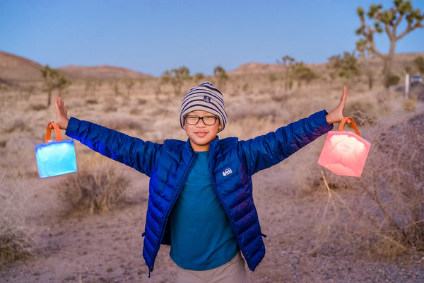 Young child holding Spectra LuminAID lanterns in Joshua Tree National Park Source: Felicia Wong 