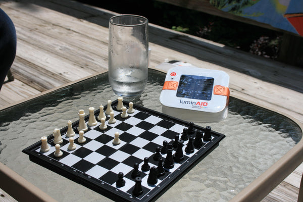 Chess set on an outdoor patio table. Source: Daphna Gall