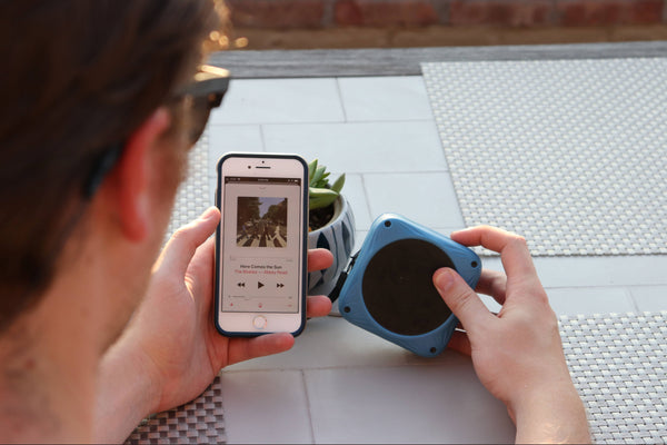 Man playing music through LuminAID Sunfox Speaker Source: Not Applicable