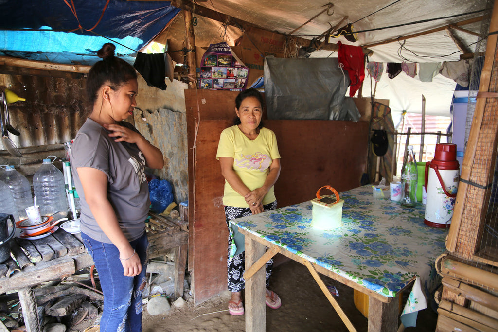 Woman with ShelterBox LuminAID Solar Lights