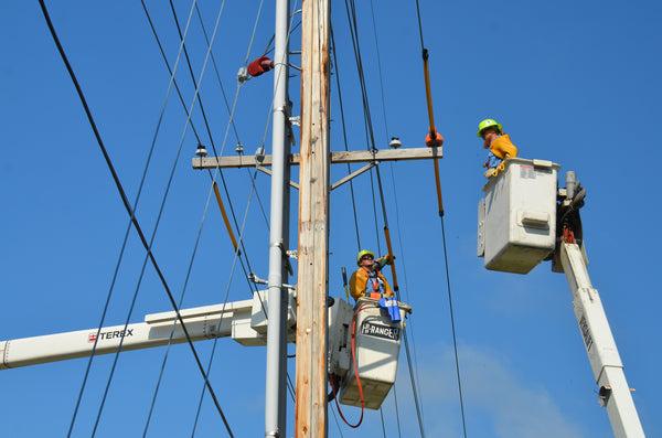 Utility workers repairing power lines. Source: American Public Power Association via Unsplash