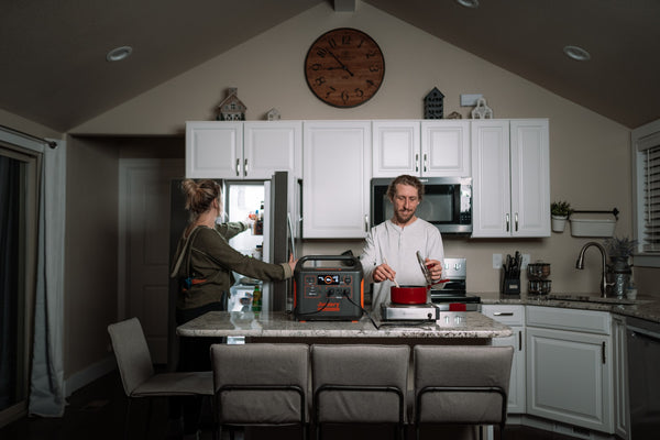 Family cooking and powering their appliances using a portable power station. Source: Jackery Power Station via Unsplash