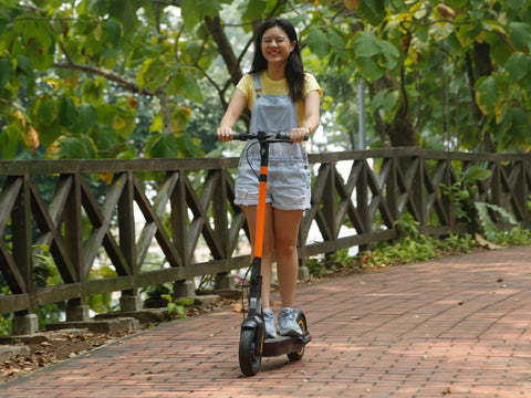a girl rides down a pathway on a segway MAX