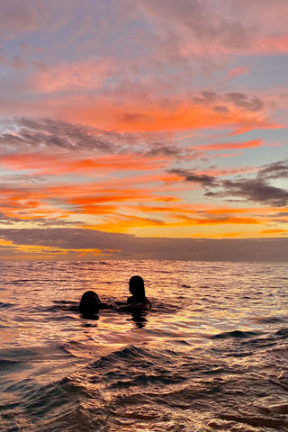 Oahu, Hawaii Sunset Picture with two people in the water